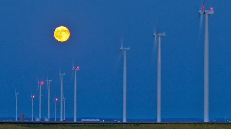 Moon over wind turbines