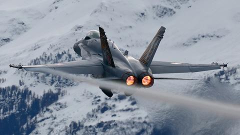 Fighter jet with snowy mountains in background