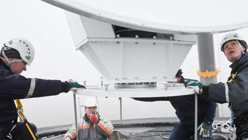 Workers installing weather radar.